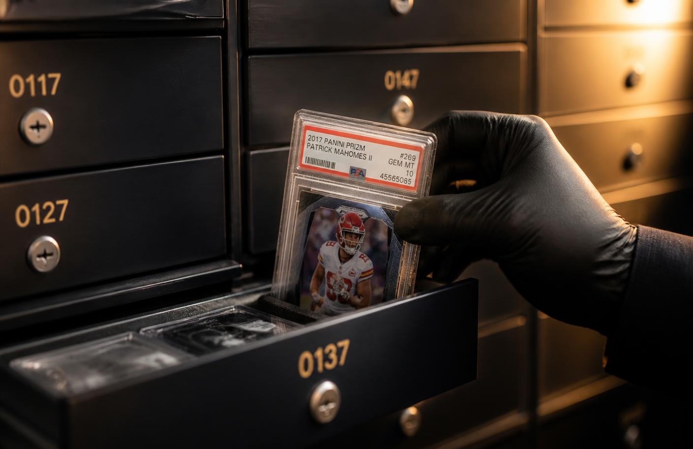Gloved hand placing a graded card into a numbered vault drawer